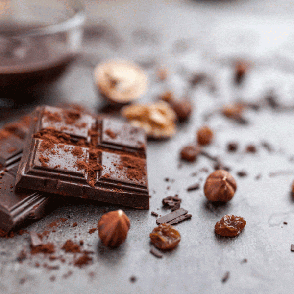 delicious-chocolate-on-a-rustic-background-2023-11-27-05-02-13-utc|Pile of hazelnut milk chocolate and nuts on dark background|dessert natural chocolate